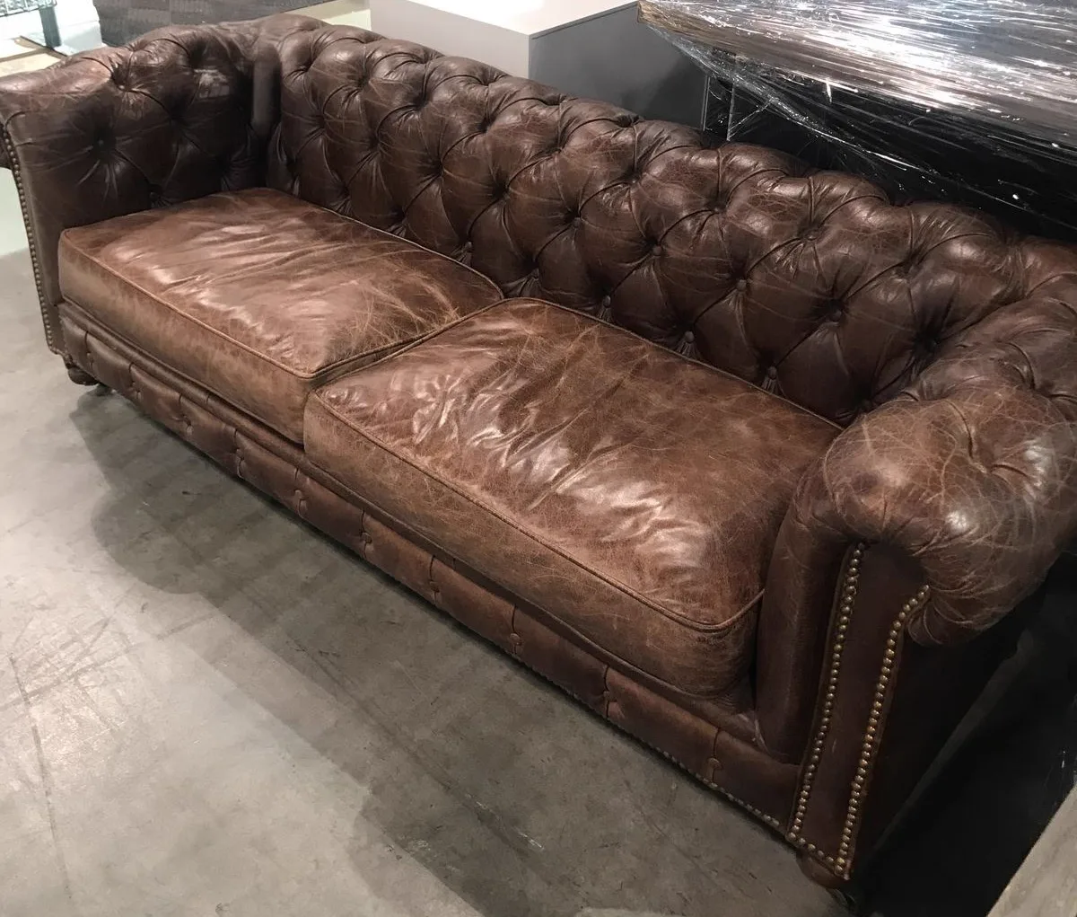 Dry, tired tan leather sofa before restoration